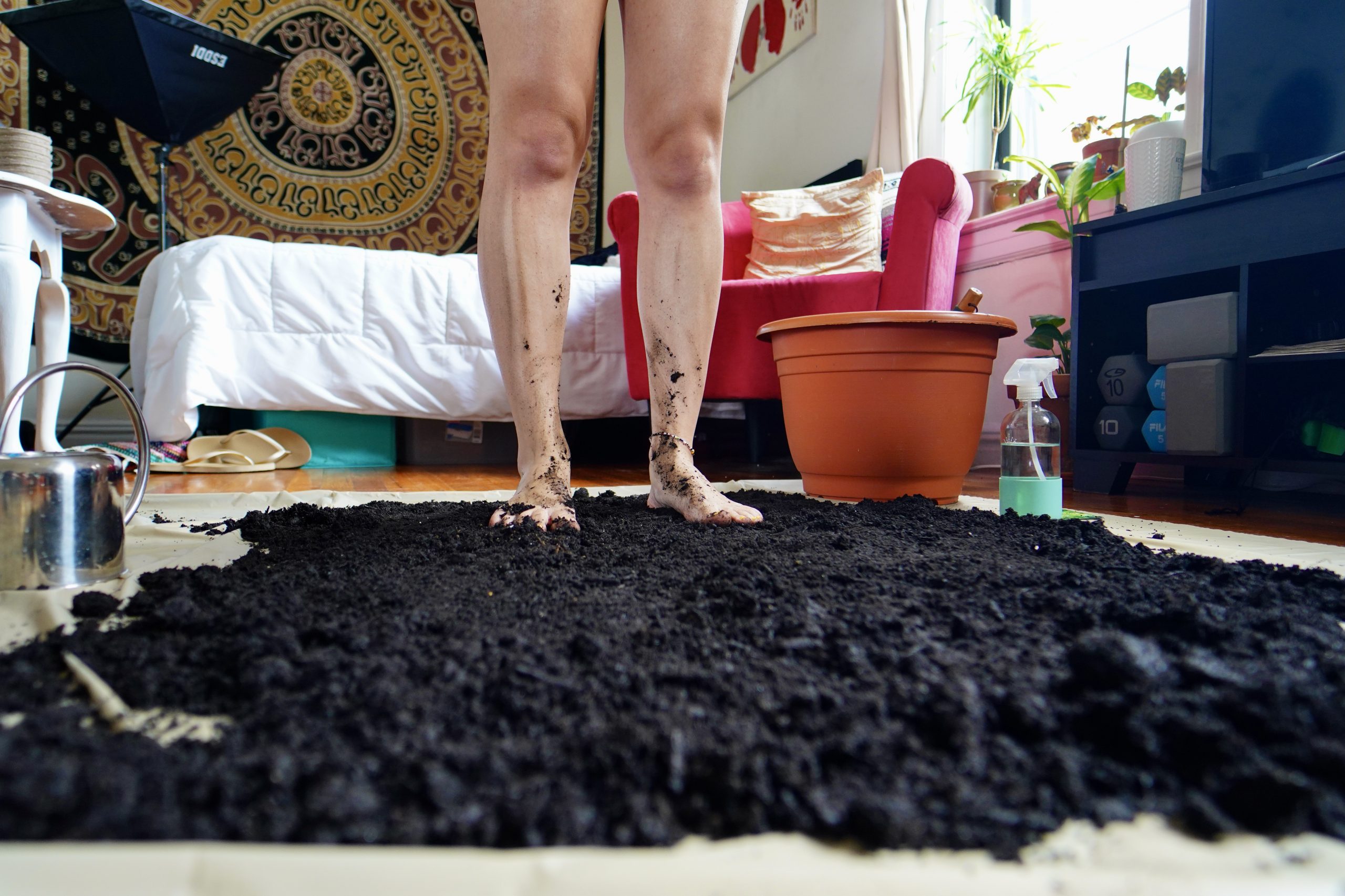 soil across bedroom floor with person standing in it