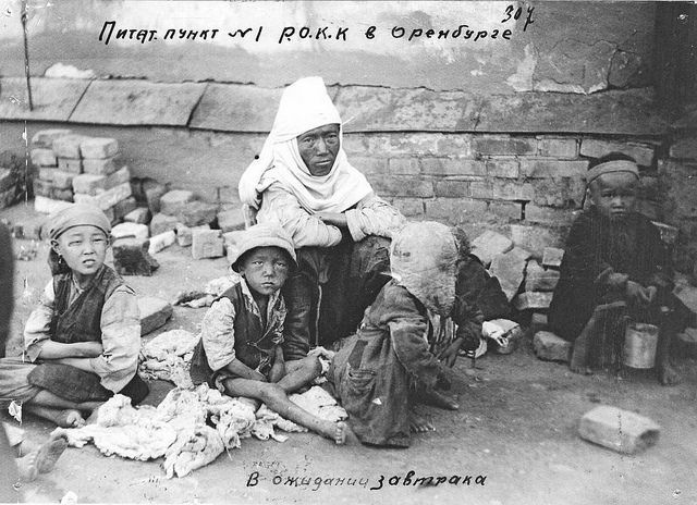 Kazakh woman and kids waiting for breakfast at food station in Orenburg